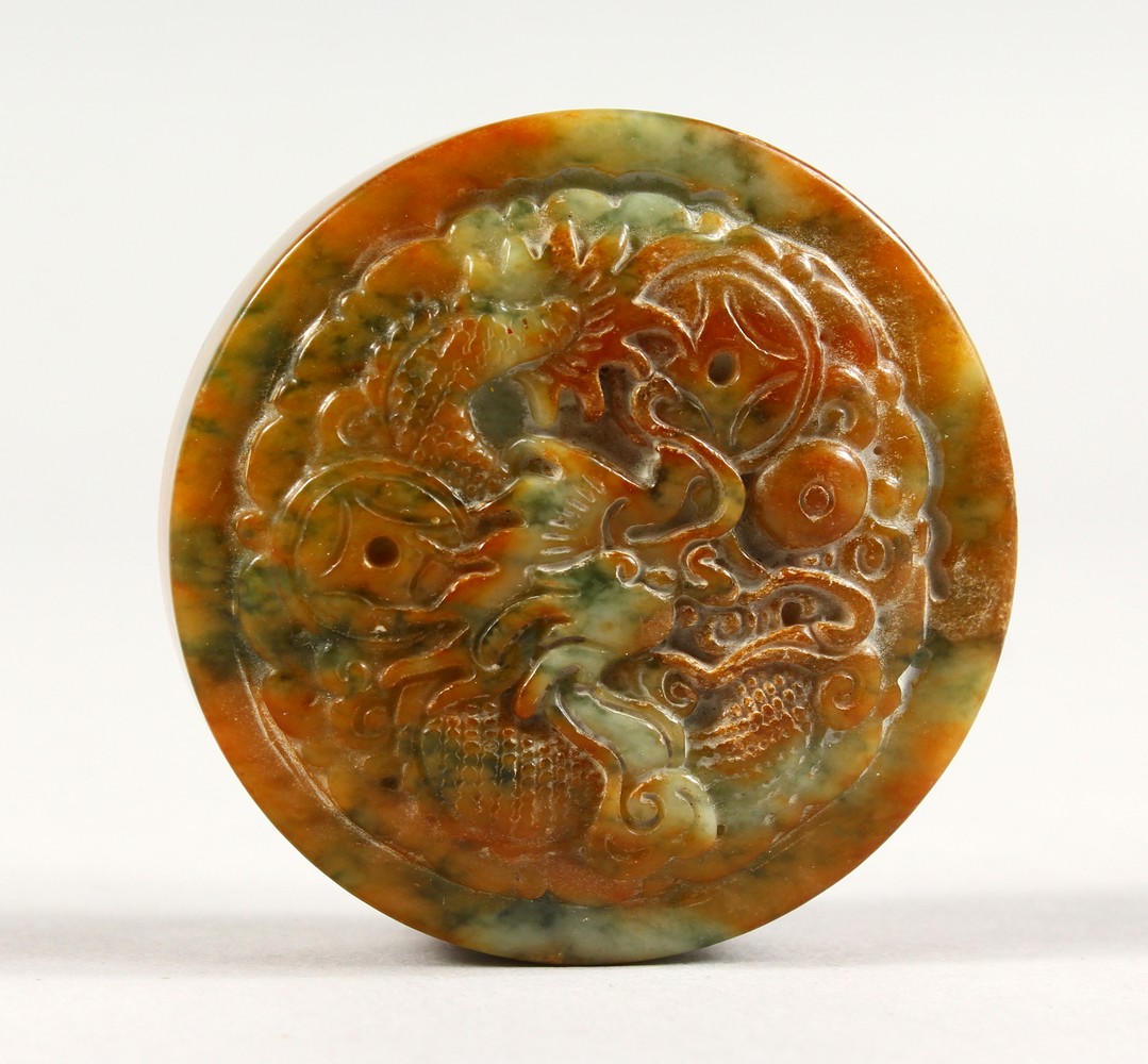 A CARVED ROUND JADE SEAL.