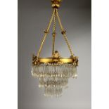 A BRASS AND CUT GLASS THREE-TIER CEILING LIGHT. 22ins high.