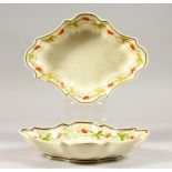 A PAIR OF WEDGWOOD OVAL BODY SHAPED CREAMWARE DISHES, decorated with oak leaves and strawberries.