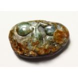 A CARVED JADE PEBBLE.