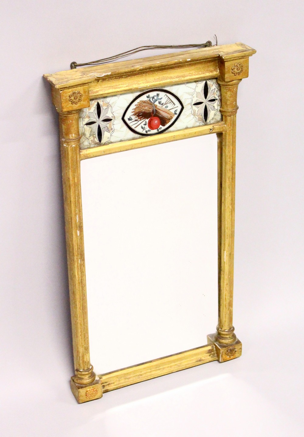 A SMALL REGENCY GILT FRAMED PIER MIRROR, with reverse painted frieze. 22.25ins high x 12.75ins