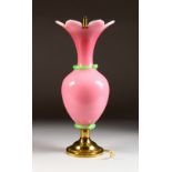 A LARGE PINK GLASS LAMP on a circular brass base. 16ins high.