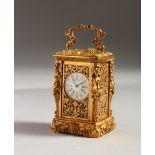 A MINIATURE GILT BRONZE CLOCK, with caryatid figures. 3ins high.