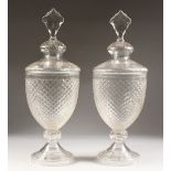 A LARGE PAIR OF HOBNAIL CUT GLASS URNS AND COVERS.