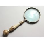 A MAGNIFYING GLASS, with mother-of-pearl handle.