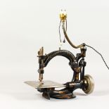 AN EARLY CAST IRON SEWING MACHINE by WILLCOX & GIBBS, New York, London & Paris.
