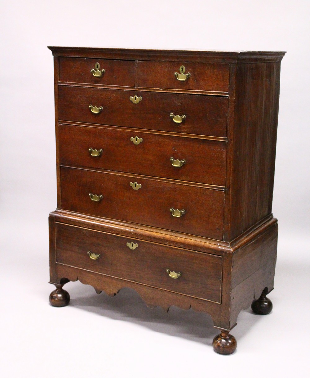 A GOOD 18TH CENTURY OAK CHEST ON STAND, the top with two short and three long graduated drawers with