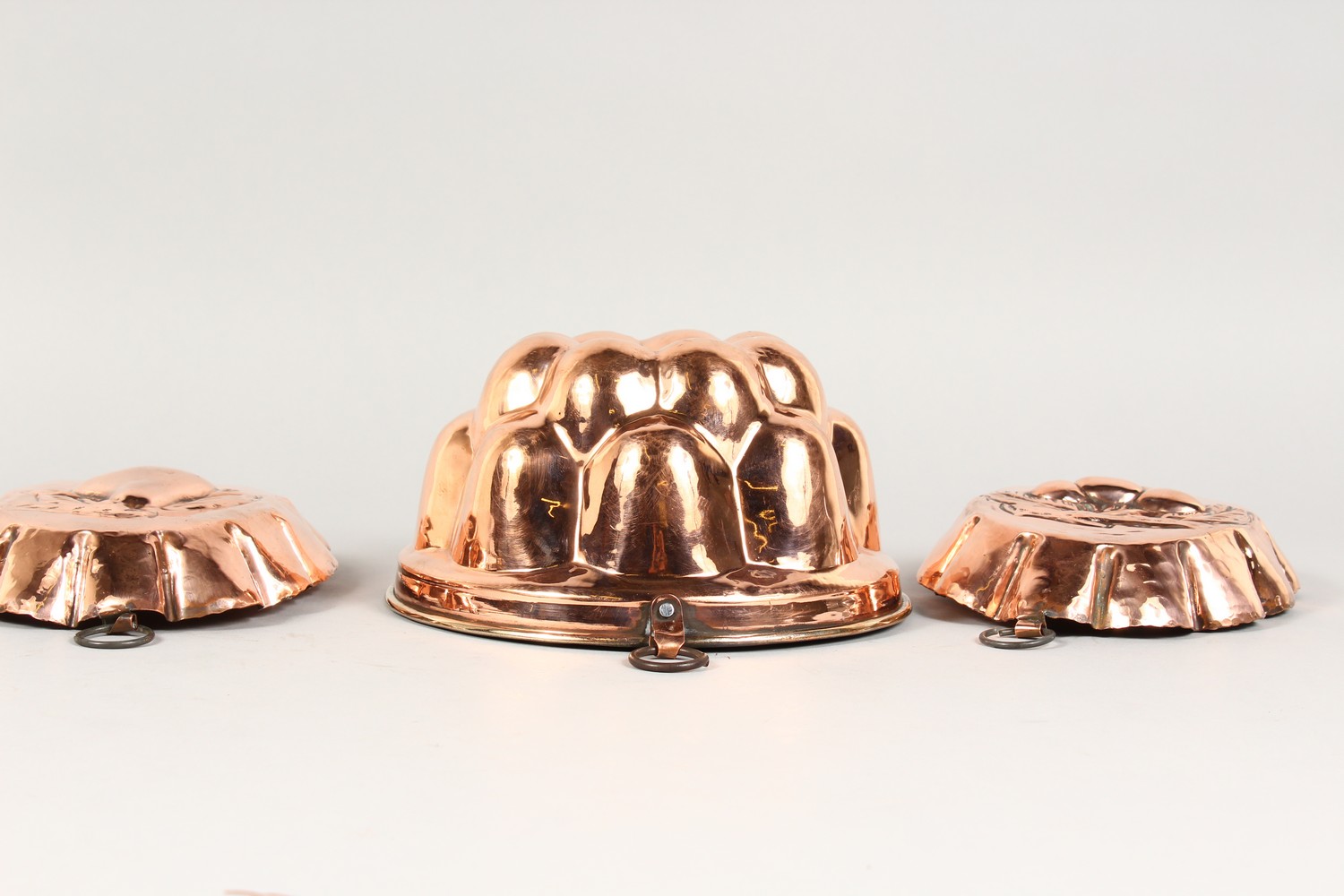 A COPPER JELLY MOULD, and a pair of oval moulds depicting fruit (3). - Image 2 of 6