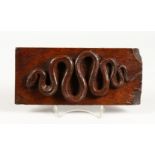 A ONE PIECE CARVING OF A SNAKE ON AN OAK PANEL. 9.5ins long.