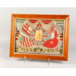 A MARITIME WOOLWORK PICTURE, depicting a photograph of a sailor within embroidered flags, framed and