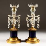 A GOOD PAIR OF FRENCH LUSTRE CANDLESTICKS, with prism drops on circular bases. 11ins high.