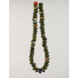 A SET OF GREEN ROMAN BEADS.