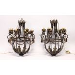 A GOOD PAIR OF WROUGHT IRON EIGHT LIGHT CHANDELIERS, with leaf and swag decoration. 32ins high.