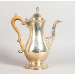 A GOOD LARGE GEORGE III PEAR SHAPED COFFEE POT, with wooden handle, gadrooning and acanthus spout,