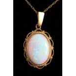 A 9CT GOLD OVAL OPAL PENDANT AND CHAIN.