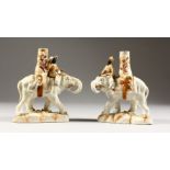 A GOOD PAIR OF CONTINENTAL PORCELAIN ELEPHANT CANDLESTICKS with rider. 6ins high.