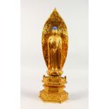 A CARVED GILTWOOD BUDDHA with blue hair, on a throne. 14ins high.