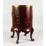 A MAHOGANY "OYSTER BARREL", the circular body with carrying handles, carved decoration, metal