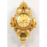 A GOOD GILT WOOD CARTEL CLOCK with circular dial, the case with scrolls and roses. 6.5ins diameter.