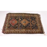 A PERSIAN QASHQAI RUG, EARLY 20TH CENTURY, blue ground with three large medallions. 7ft 8ins x 5ft