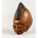 A CARVED WOOD AFRICAN MASK, with part painted decoration. 10ins long.