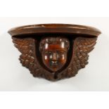 A 19TH CENTURY CHERUB WALL BRACKET. 13.5ins wide.