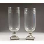 A PAIR OF CUT GLASS STORM LAMPS, on square stepped bases. 1ft 4ins high.