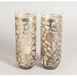 A PAIR OF SILVER OVERLAY VASES. 7ins high.