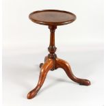 A GEORGIAN MAHOGANY KETTLE STAND, with circular top. 10ins diameter, on a tripod base.