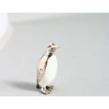 A TINY NOVELTY SILVER AND ENAMEL PENGUIN.