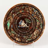 TERRY WILKINS (BOMBAY SCHOOL OF ART). A LARGE CIRCULAR POTTERY CHARGER, enamel decorated with a