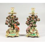 A RARE PAIR OF CHELSEA DERBY BOCAGE CANDLESTICK GROUPS, with a fox in a well and a goat in a well