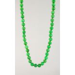 A STRING OF JADE BEADS.