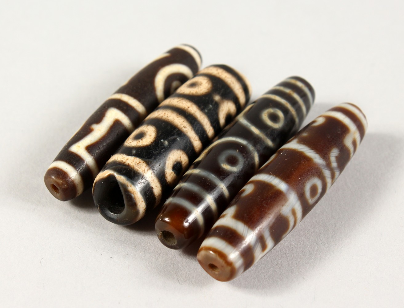 FOUR AGATE BEADS.