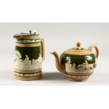 A COPELAND GREEN AND BROWN GLAZE POTTERY TEAPOT AND JUG, with hunting scenes.