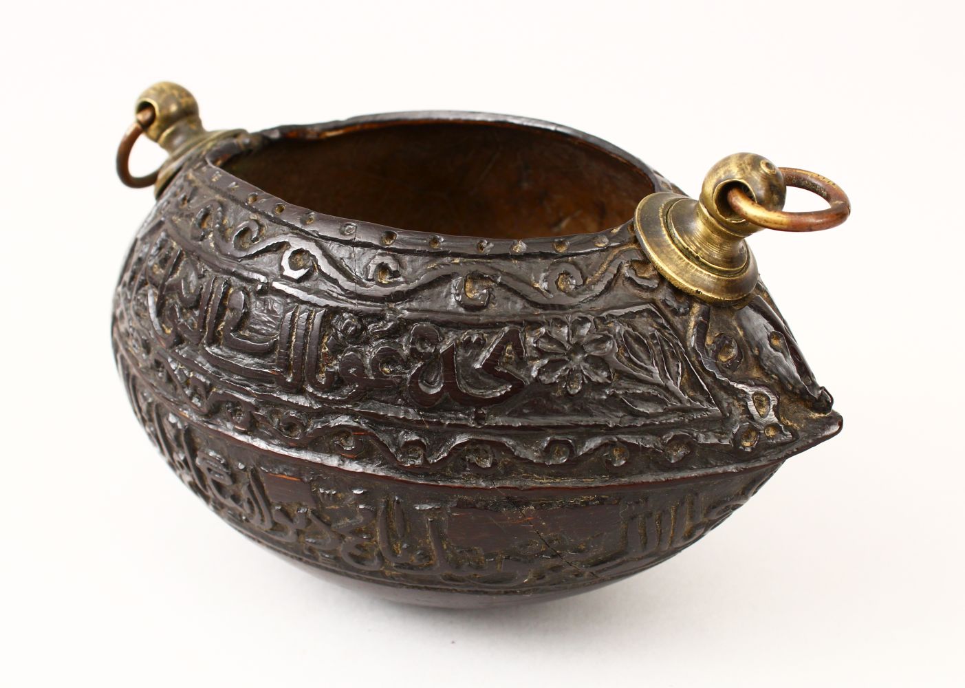 A GOOD 19TH CENTURY ISLAMIC COCO KASHKOOL, carved with Islamic calligraphy and scroll decoration