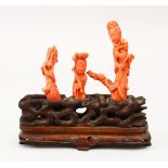 A GOOD 19TH CENTURY CHINESE CARVED CORAL GROUP ON STAND - guanyin, the coral pieces carved to depict