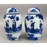 A PAIR OF 19TH CENTURY CHINESE BLUE & WHITE PORCELAIN JARS & COVERS, decorated with scenes of