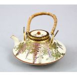 A JAPANESE MEIJI PERIOD SATSUMA TEAPOT & LID, the pot decorated with scenes of hanging wisteria, the
