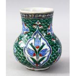 A GOOD IZNIK POTTERY BULBOUS VASE, decorated with typical panels of flora upon a green wave style