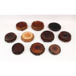A MIXED LOT OF TEN 19TH / 20TH CENTURY CHINESE CARVED HARDWOOD STANDS, largest 20.5cm diameter,