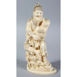 A GOOD JAPANESE MEIJI PERIOD CARVED IVORY OKIMONO OF MAN AN BABY, the man carved with a humorous