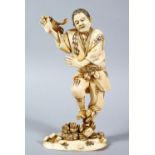 A GOOD JAPANESE MEIJI PERIOD CARVED IVORY OKIMONO OF A FISHERMAN & CRABS, the fisherman stood