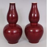 A PAIR OF CHINESE COPPER RED DOUBLE GOURD PORCELAIN VASES, each base with a six-character Kangxi