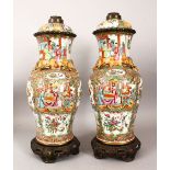 A PAIR OF CHINESE 19TH CENTURY CANTON PORCELAIN VASES / LAMPS, with panel decoration of figures,