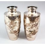 A GOOD PAIR OF JAPANESE LATE MEIJI PERIOD SILVER VASES, the body of the vases engraved with native