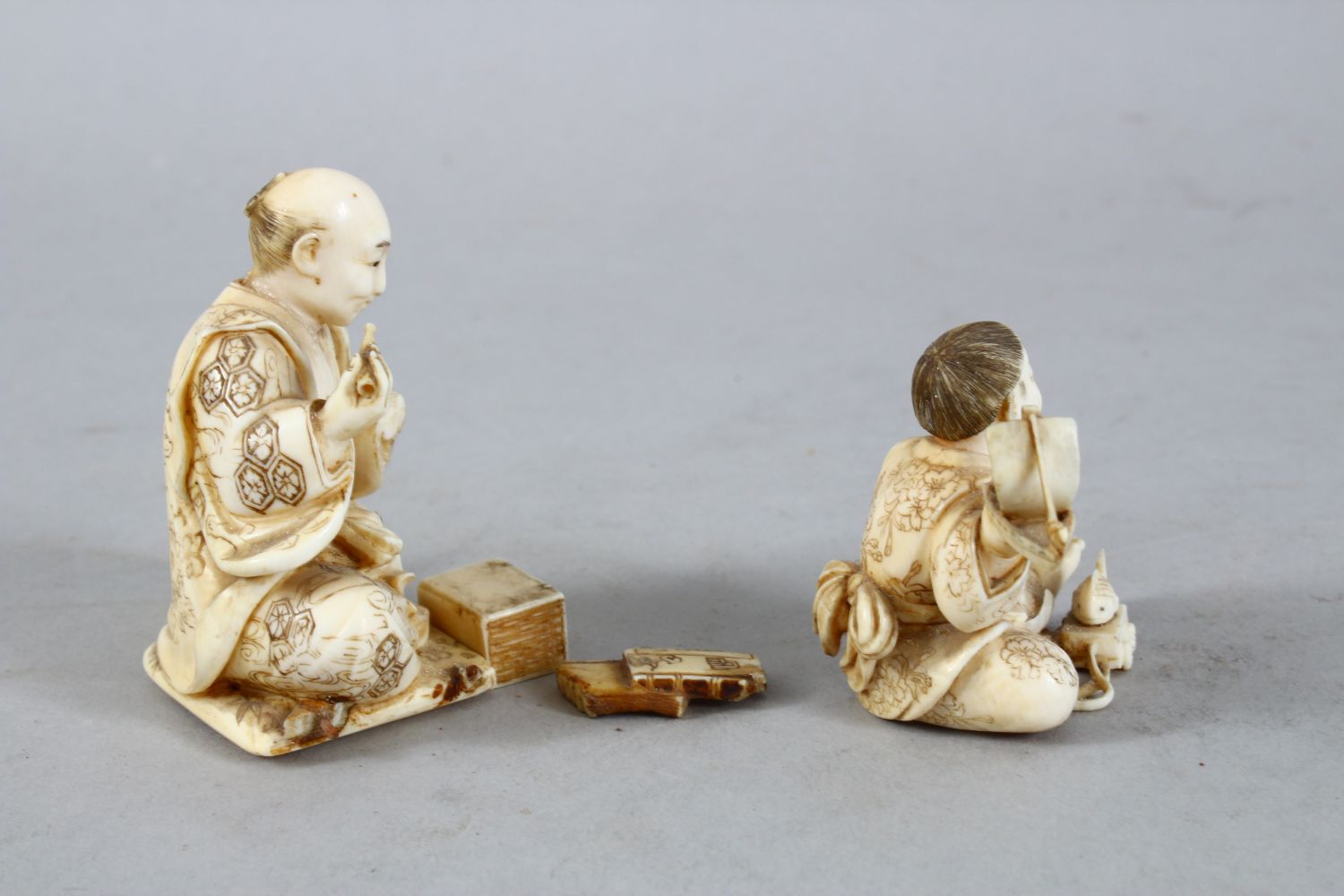 TWO JAPANESE MEIJI PERIOD CARVED IVORY OKIMONO, one carved to depict a seated artisan, the base with - Image 4 of 12