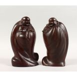 A GOOD PAIR OF 19TH / 20TH CENTURY CHINESE CARVED HEAVY HARD WOOD FIGURES OF BUDDHA, the mirror pair