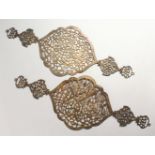 A GOOD PAIR OF ISLAMIC WHITE METAL PIERCED CALLIGRAPHIC PLAQUES, The pair of pierced plaques with