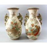 A GOOD PAIR OF JAPANESE MEIJI PERIOD SATSUMA TWIN HANDLE BALUSTER VASES, each vase with applied blue